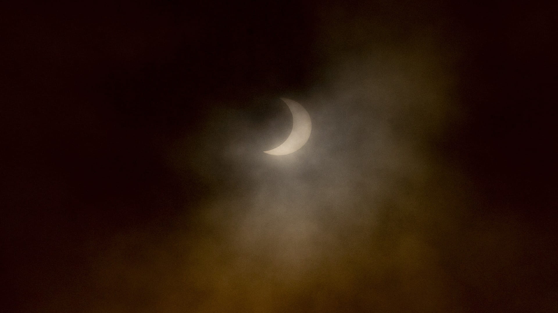 Image for the title: Thousands watch solar eclipse in Chile but fog, clouds mar view 