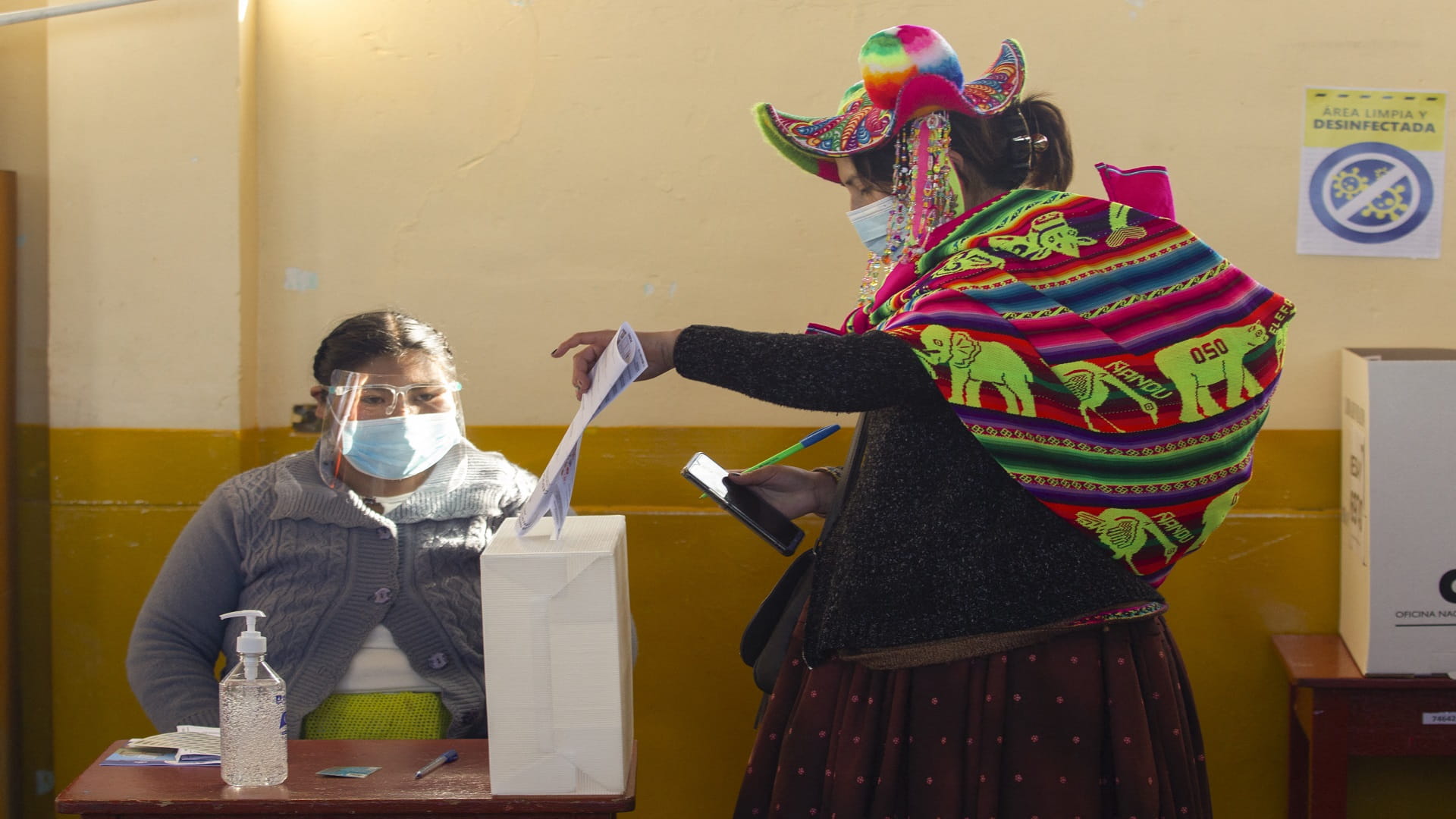 Image for the title: Peruvians vote for president amid deadly coronavirus surge 