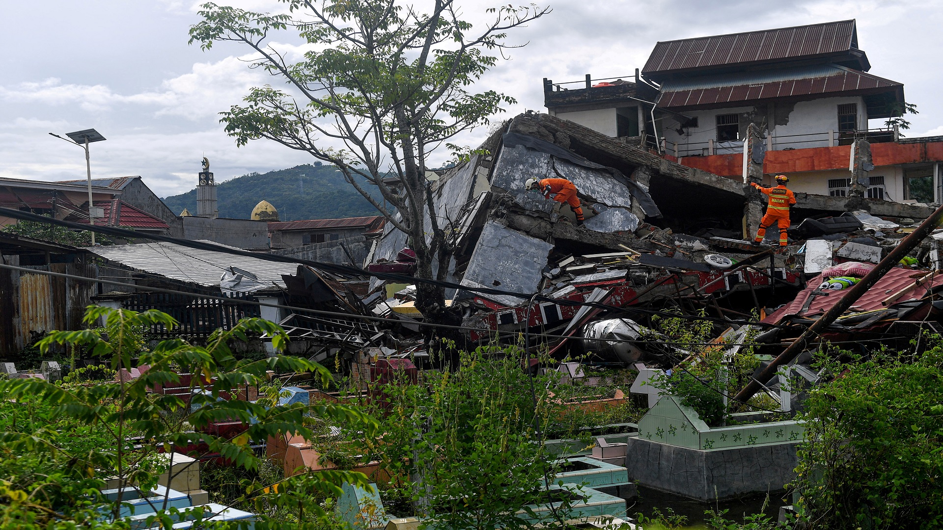 Image for the title: Quake death toll at 56 as Indonesia struggles with disasters 