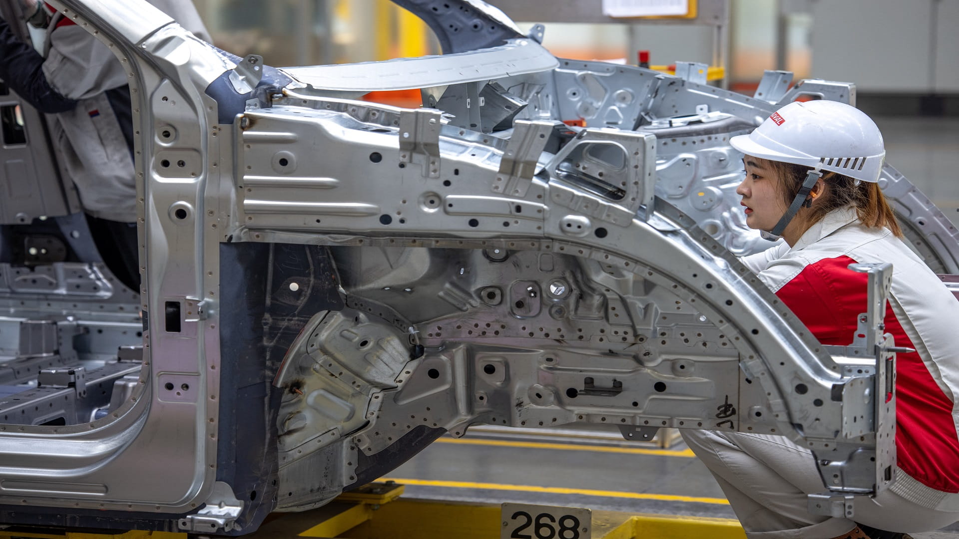 Image for the title: China factory activity nudges down on slower demand 