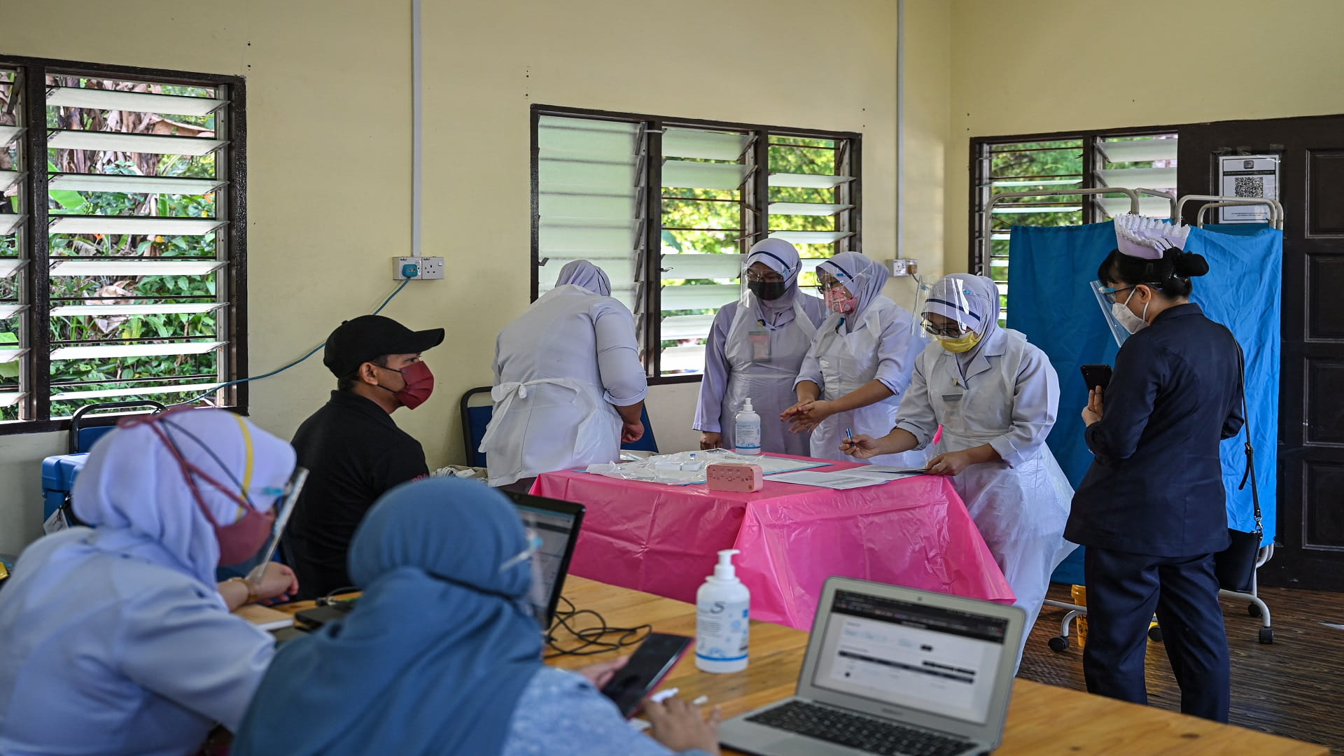 Image for the title: Malaysia sees record 15,573 new coronavirus cases 