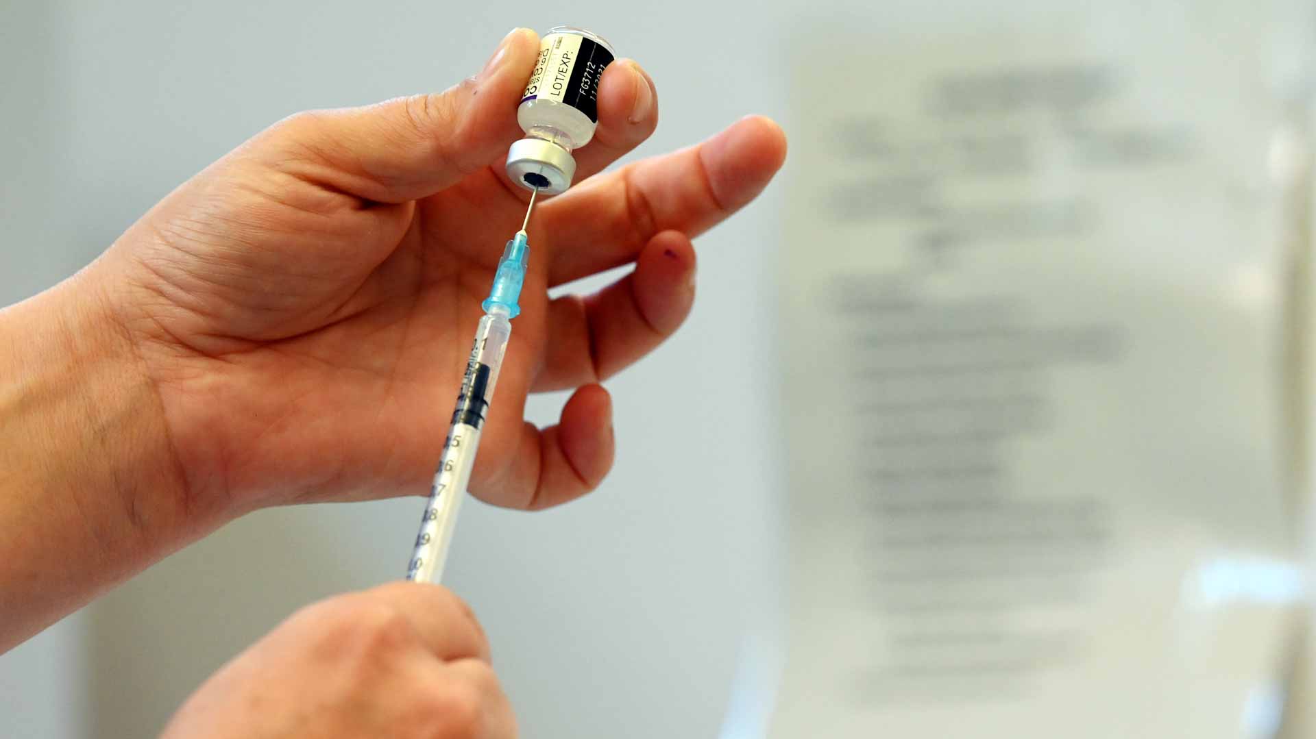 Image for the title: Britain allows early booking of booster shots to speed up rollout 