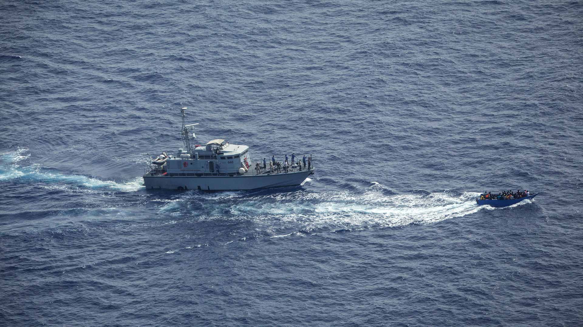 Image for the title: Italy lets 800 migrants stuck at sea disembark 