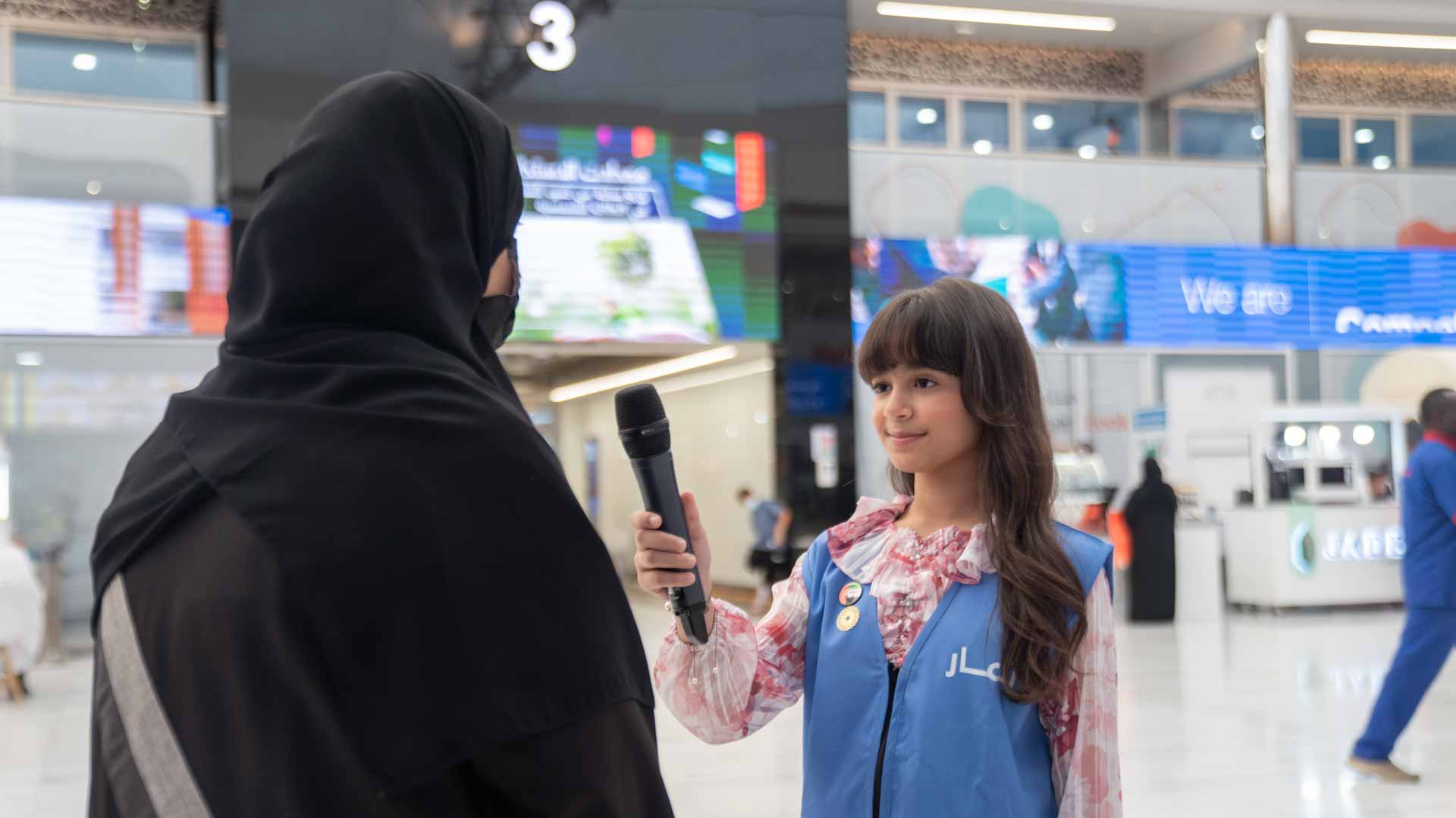 Image for the title: Ithmar trainees hone media skills by interviewing SIBF attendees 