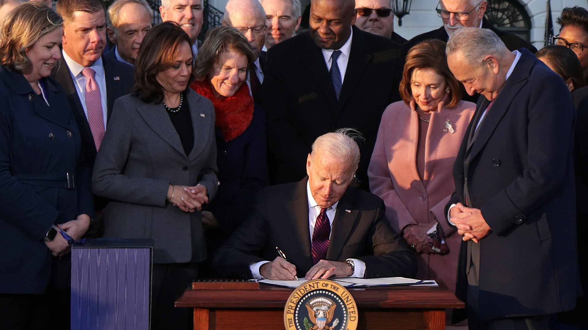 Image for the title: Biden signs $1 trillion infrastructure bill into law 