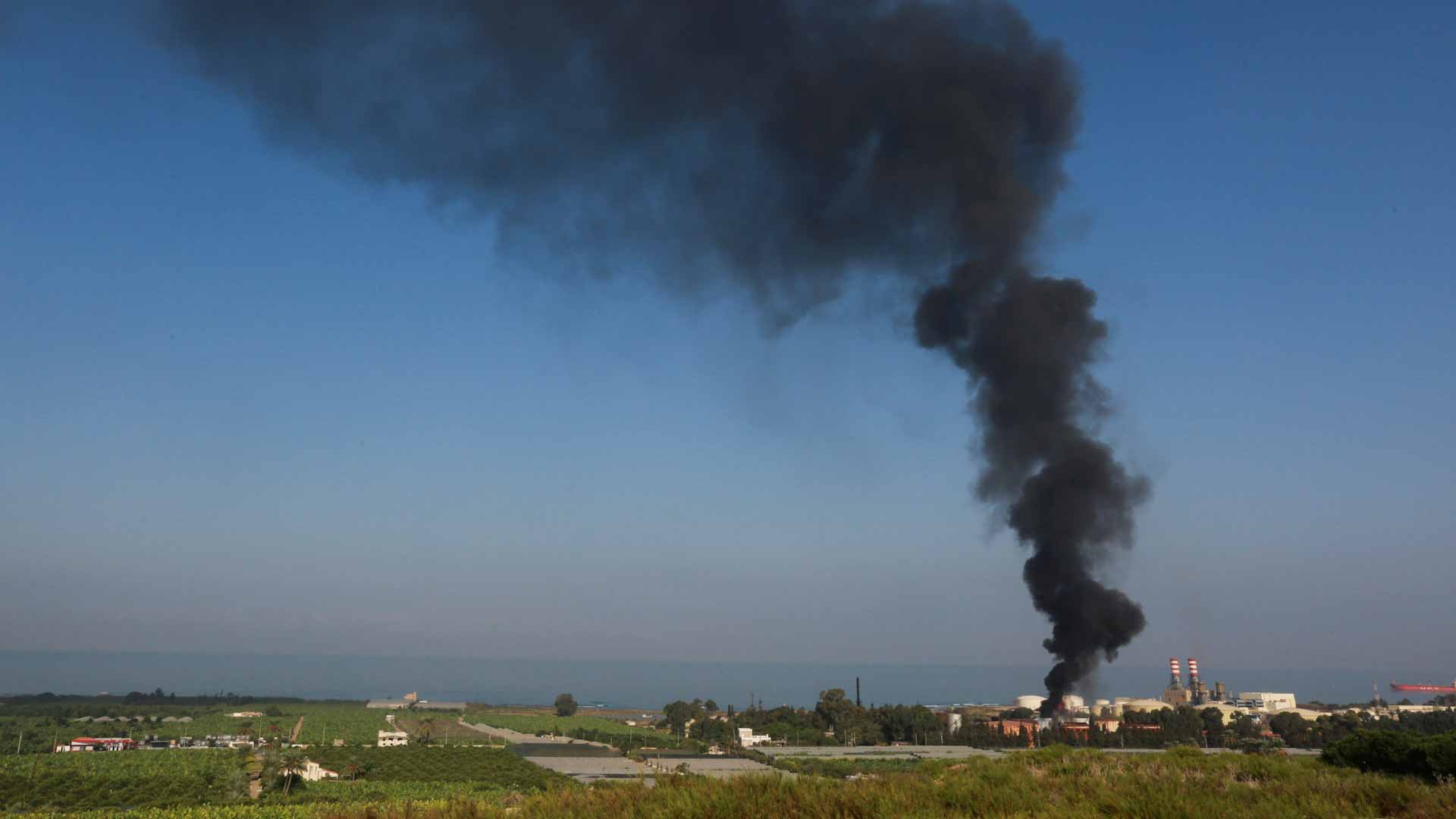 Image for the title: Firefighters battle blaze at southern Lebanon fuel storage tank 