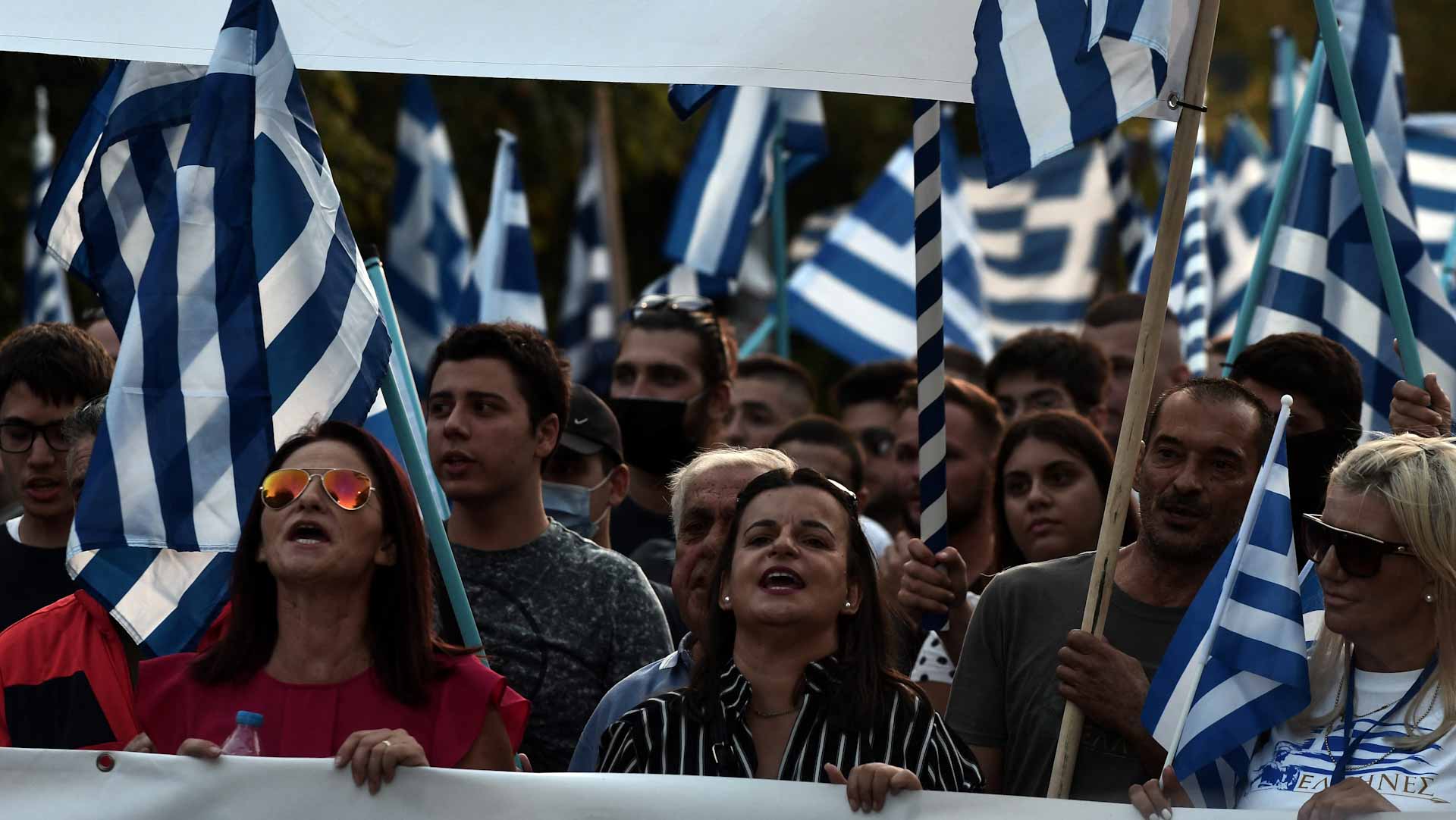 Image for the title: Anti COVID vaccine protesters clash with police in Greece 