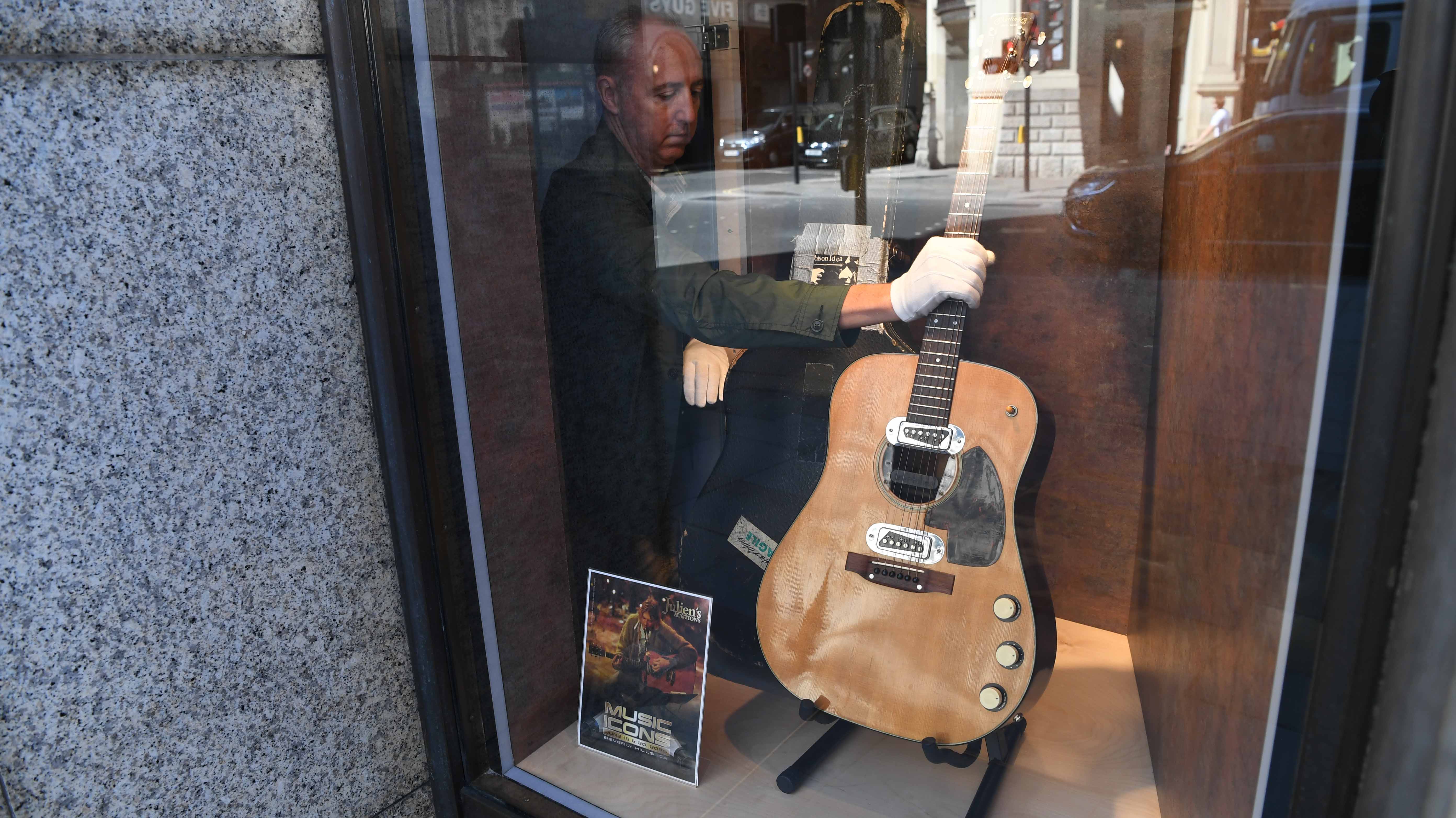 Image for the title: Kurt Cobain’s blue guitar goes up for auction 