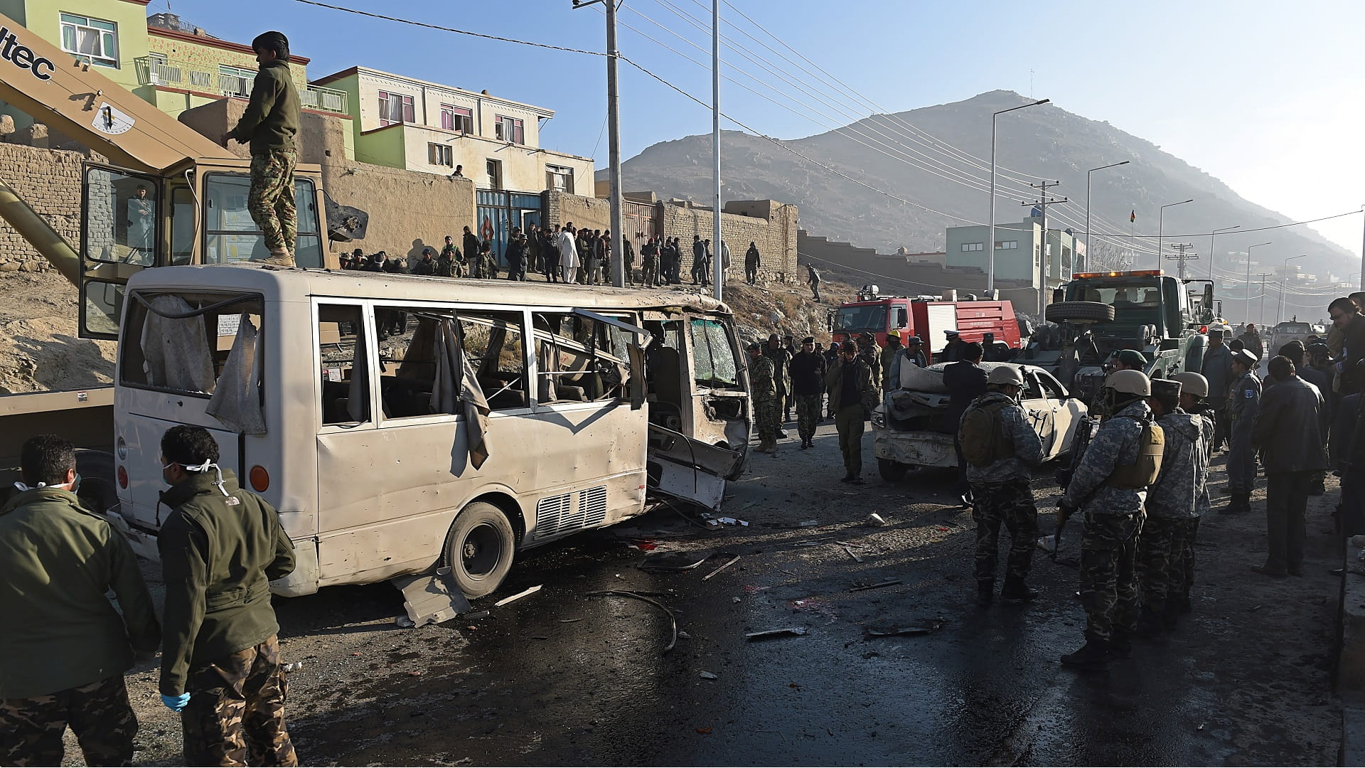 Image for the title: At least nine killed by bomb blasts on minibuses in Afghan city 