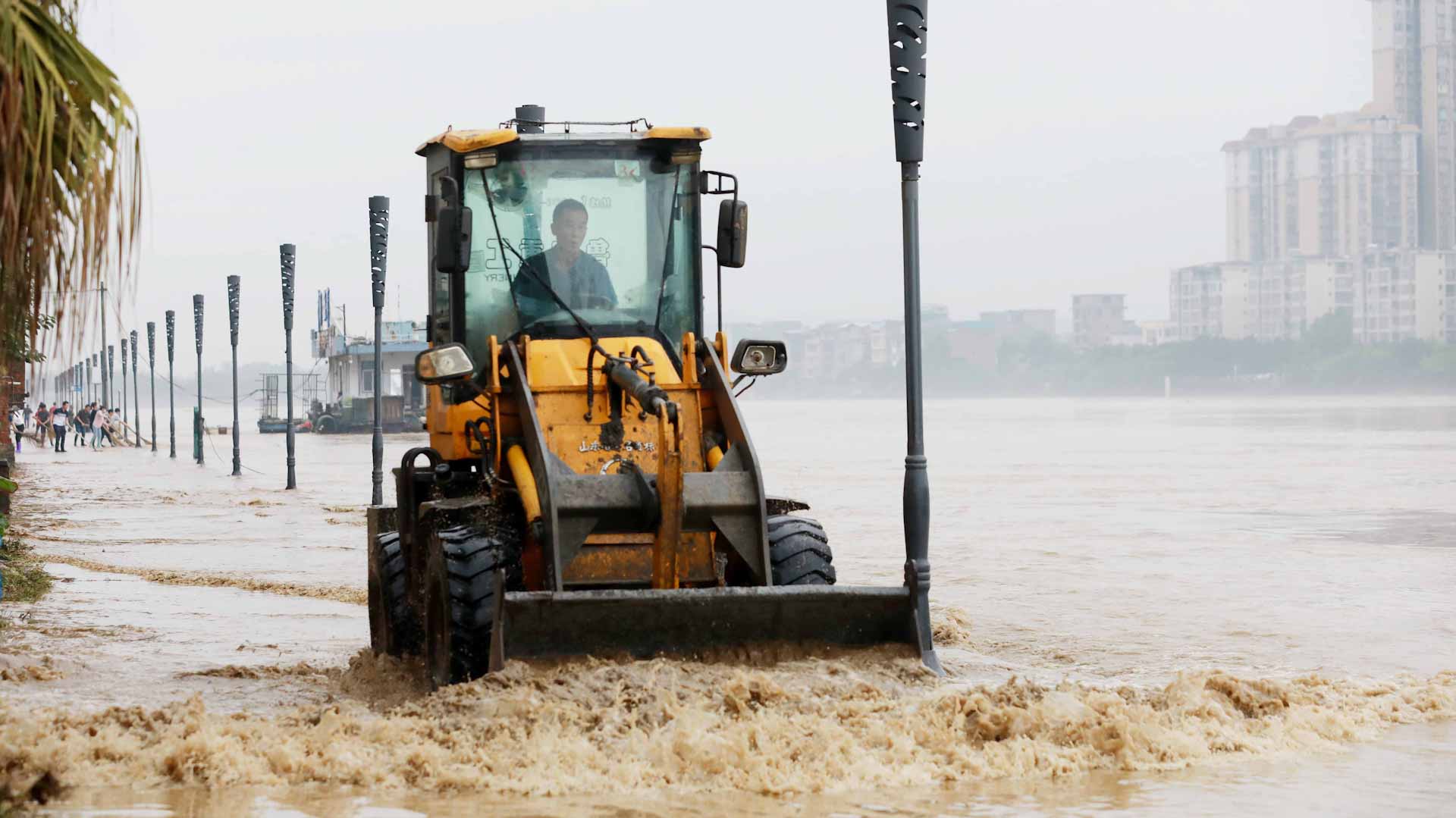 Image for the title: Rainstorms lash northeast China, trapping cars, buses in floods 