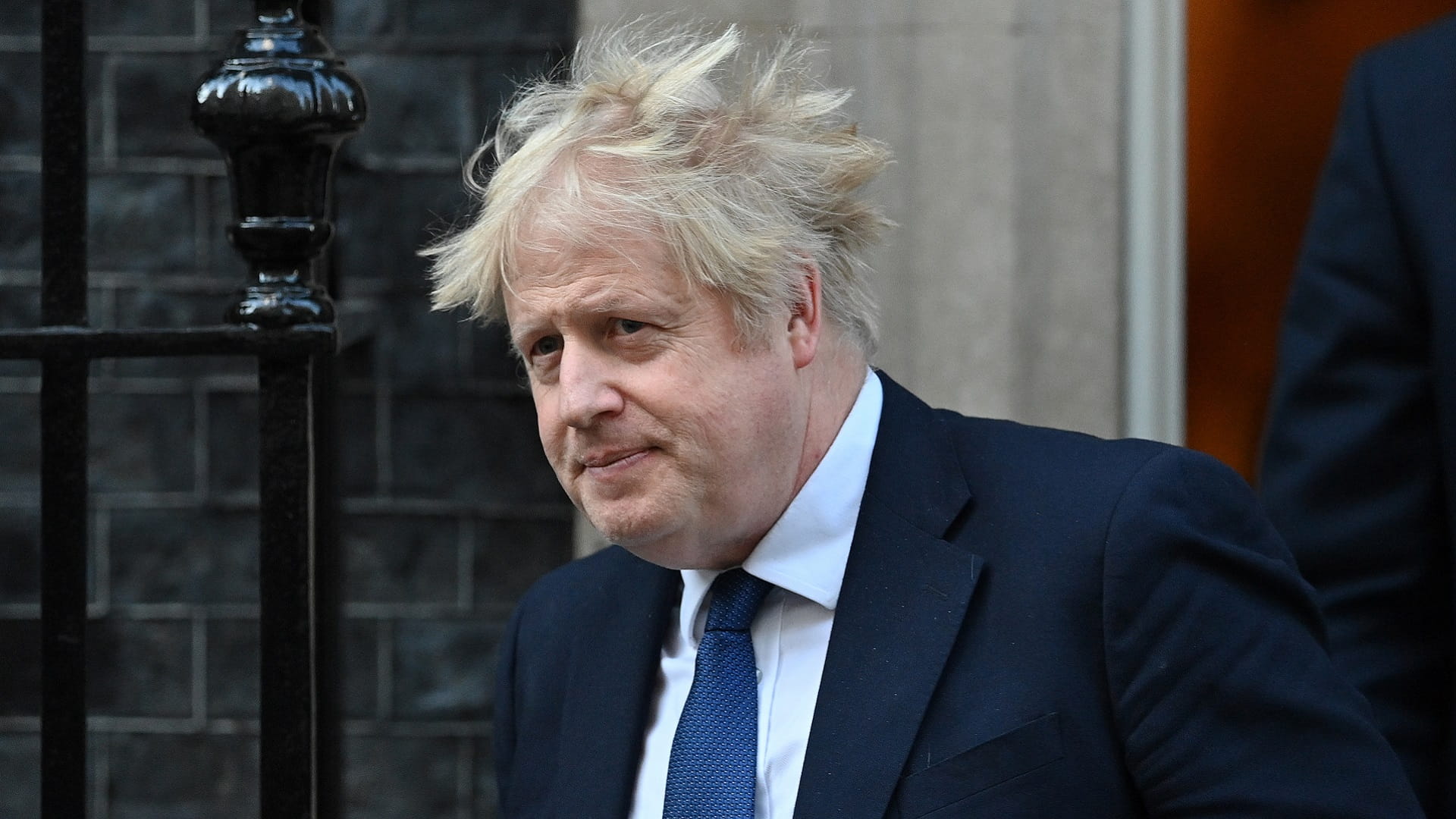 Image for the title: UK's Johnson digs in as ministers desert government 