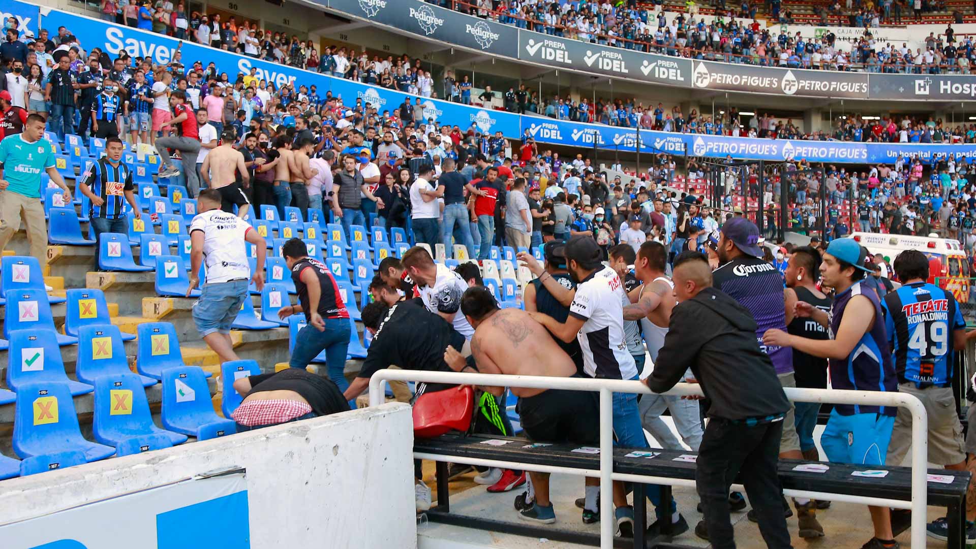 Image for the title: Dozens injured as fans clash at Mexico football match 