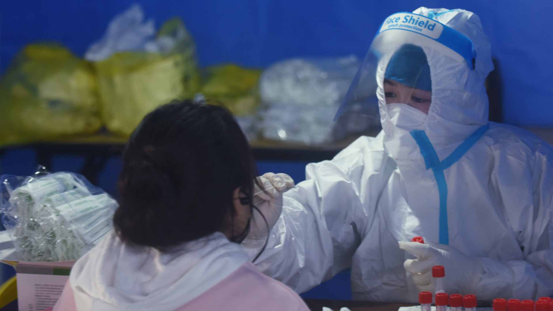 Image for the title: Millions locked down as China wrestles worst virus outbreak in 2Y 