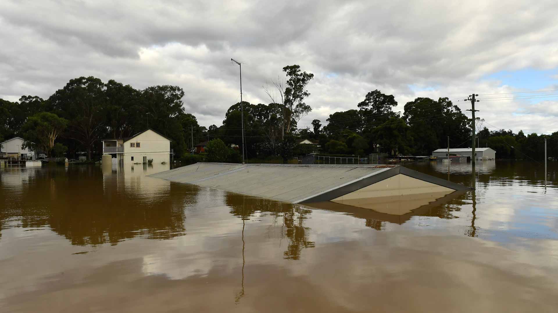Image for the title: As floods ease, Australia braces for damaging surf and wind 