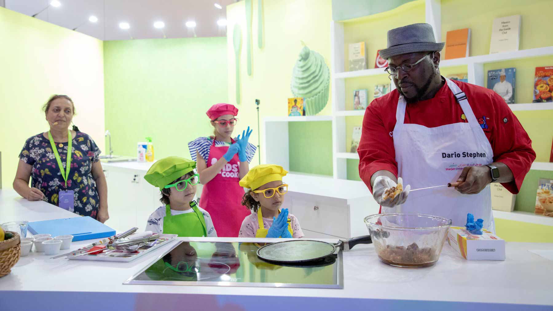 Image for the title: Children take charge of kitchen during a live cooking demo at SCRF 