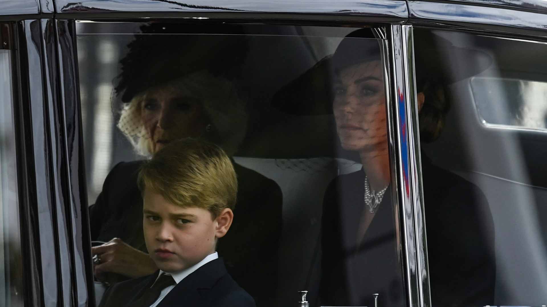 Image for the title: Queen's great-grandchildren George and Charlotte follow coffin 