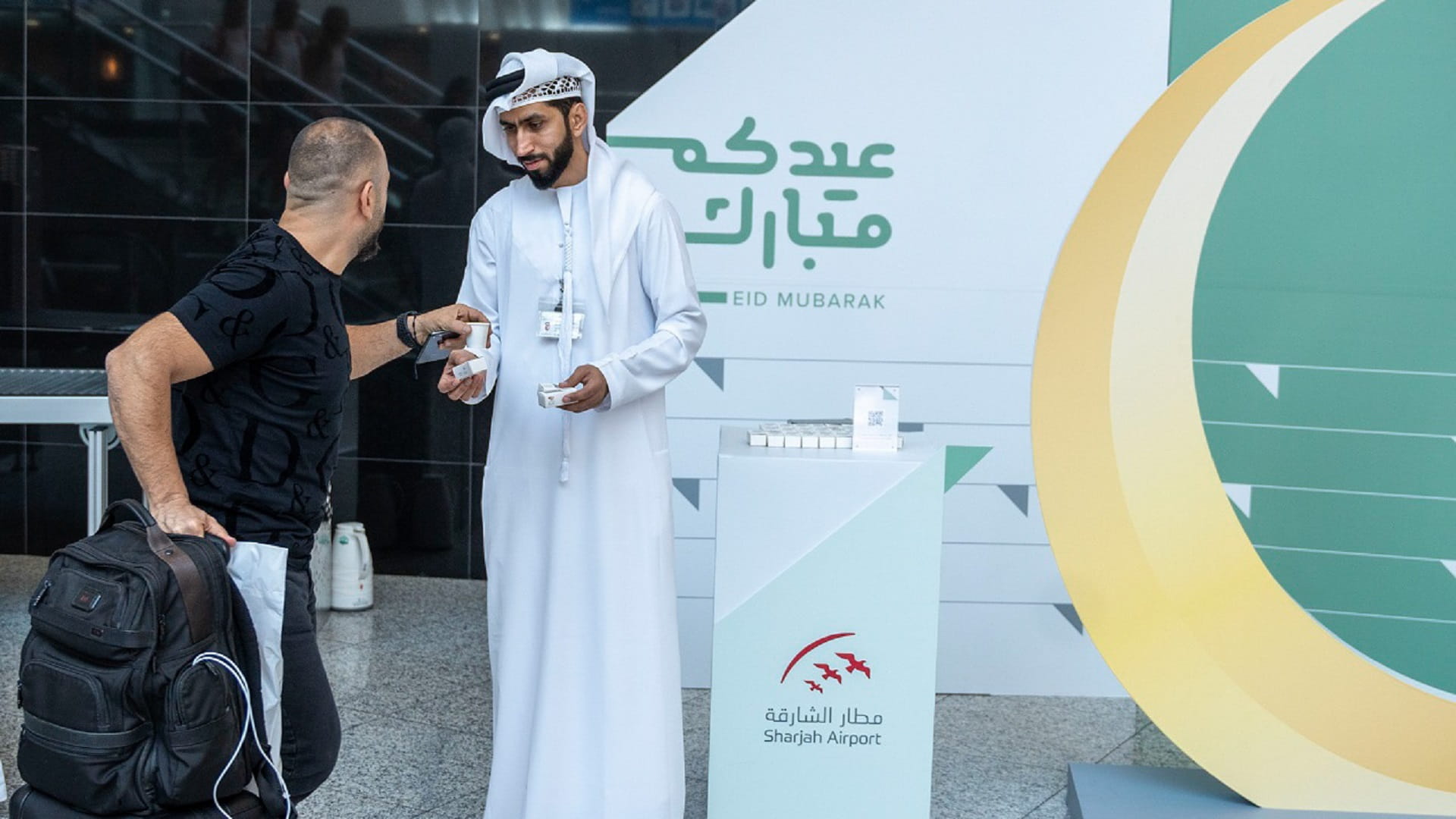 Image for the title: Sharjah Airport welcomes passengers with Eid presents, flowers 