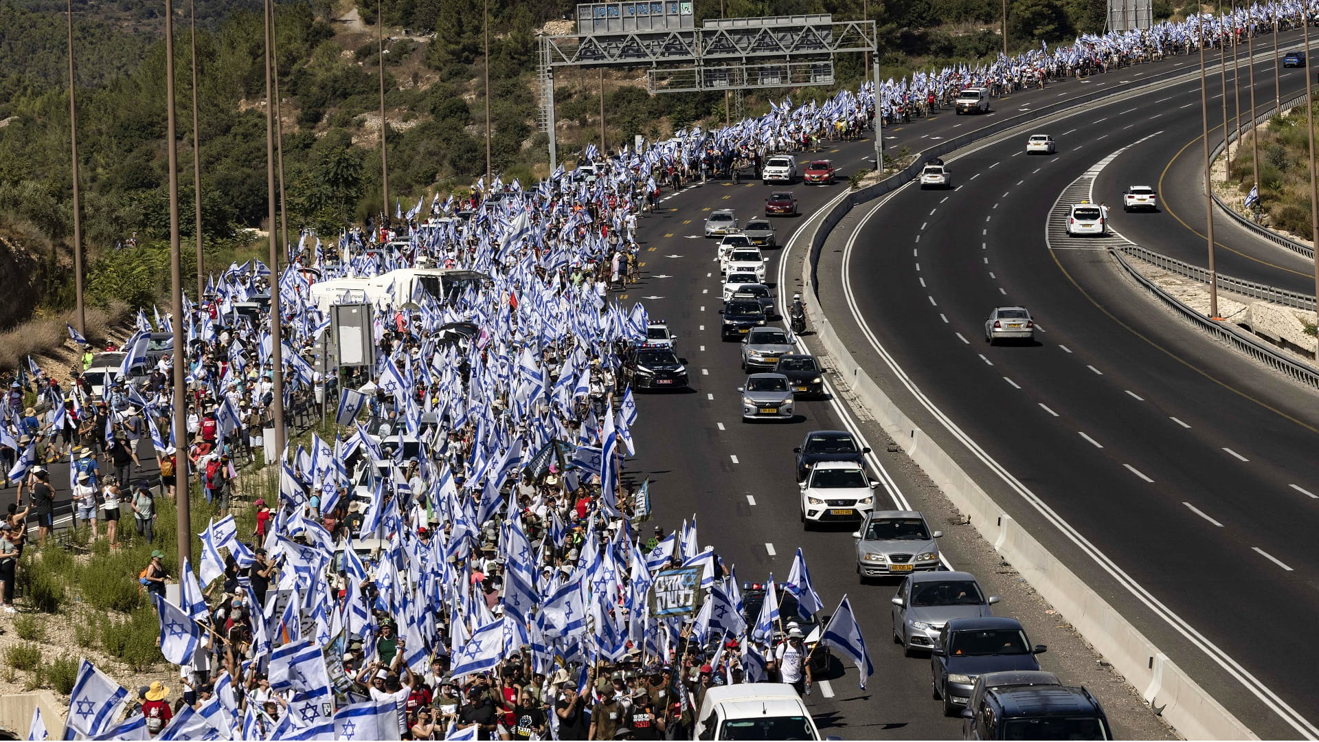 Image for the title: Thousands of Israelis march as vote on judicial curbs nears 