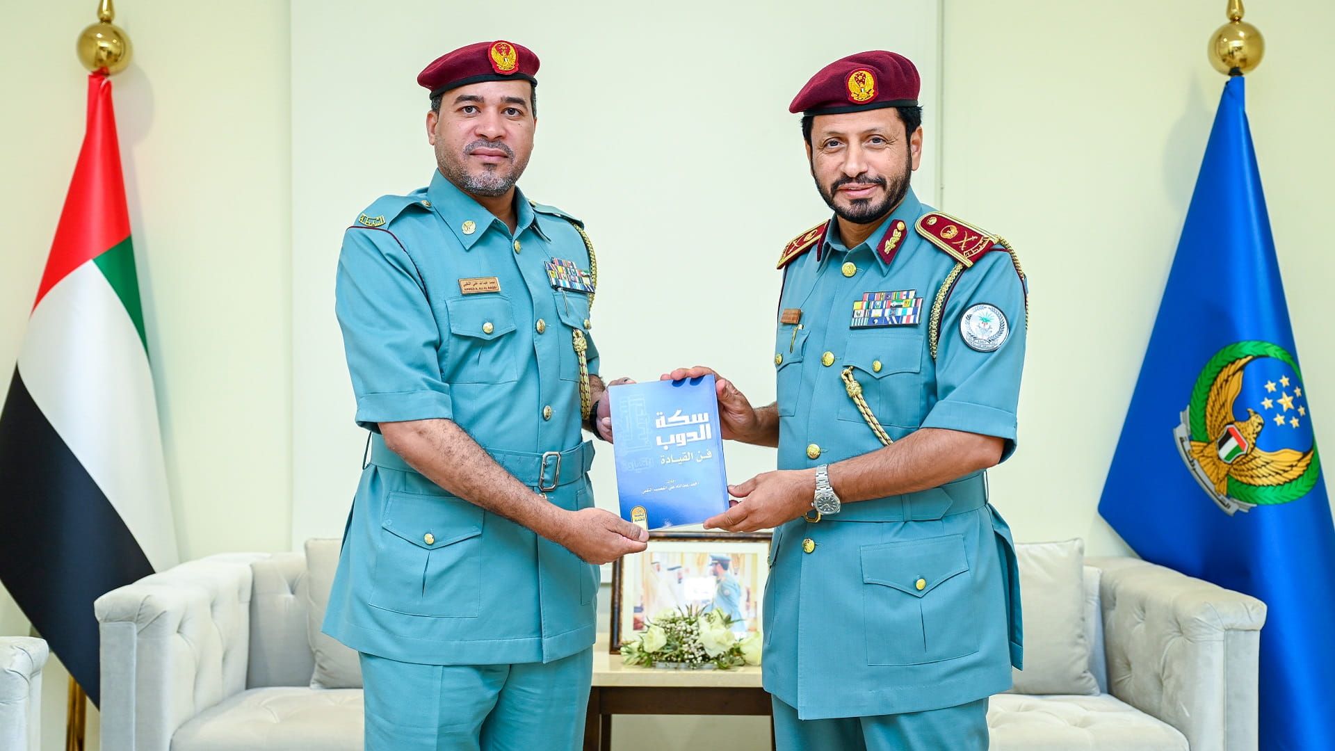 Image for the title: Al Shamsi receives Al Naqbi's book on leadership 