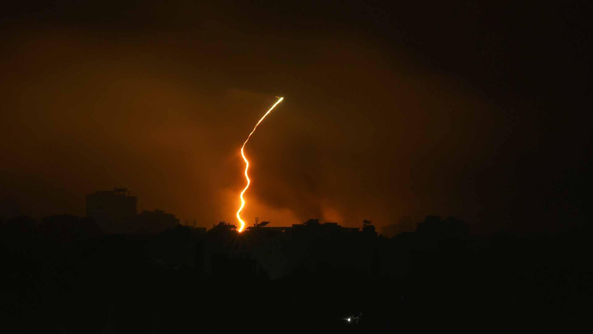 Image for the title: Israel pounds Gaza City as tens of thousands flee their homes 