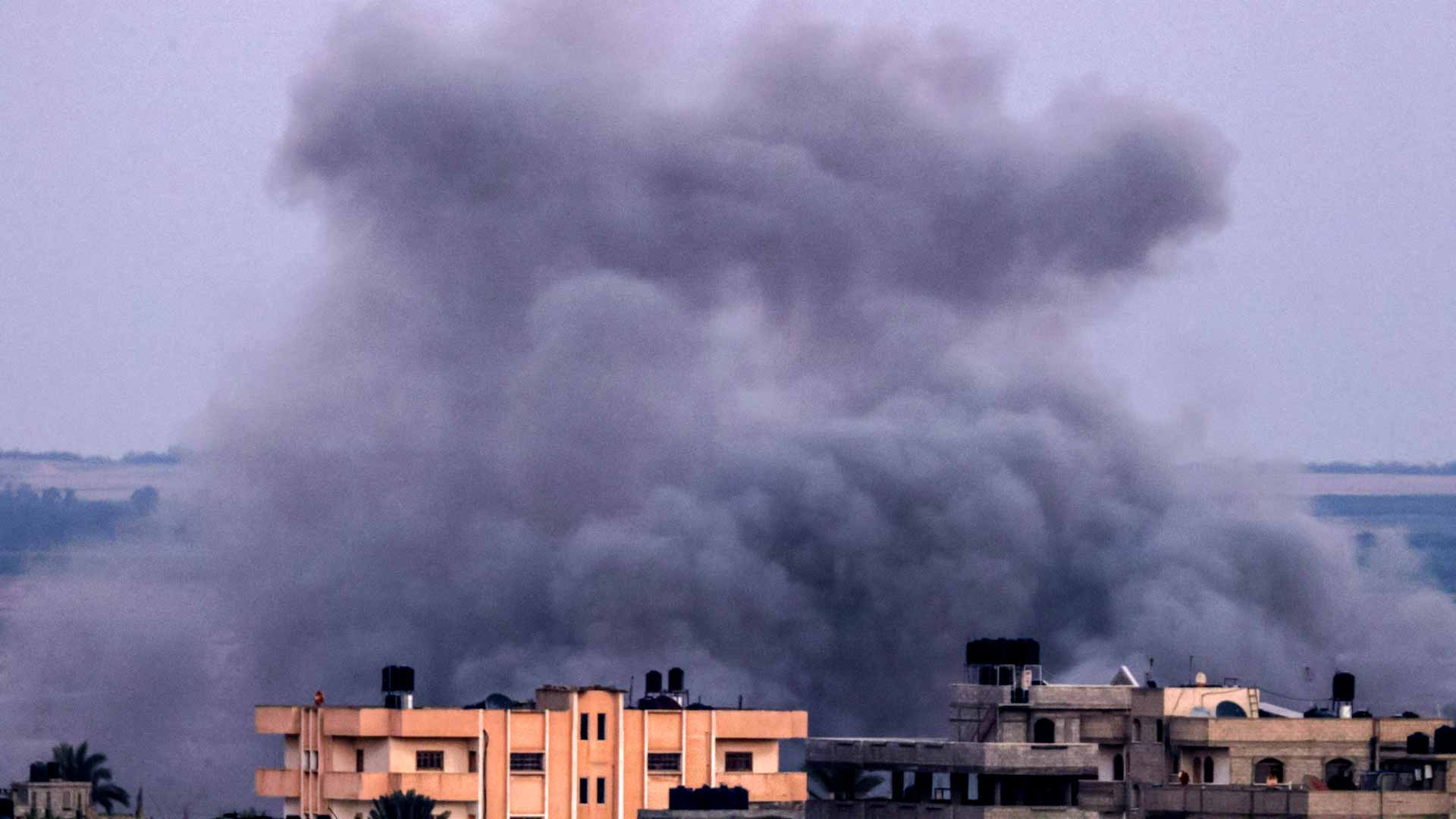 Image for the title: Bomb craters and bodies as Gazans evacuate hospital 