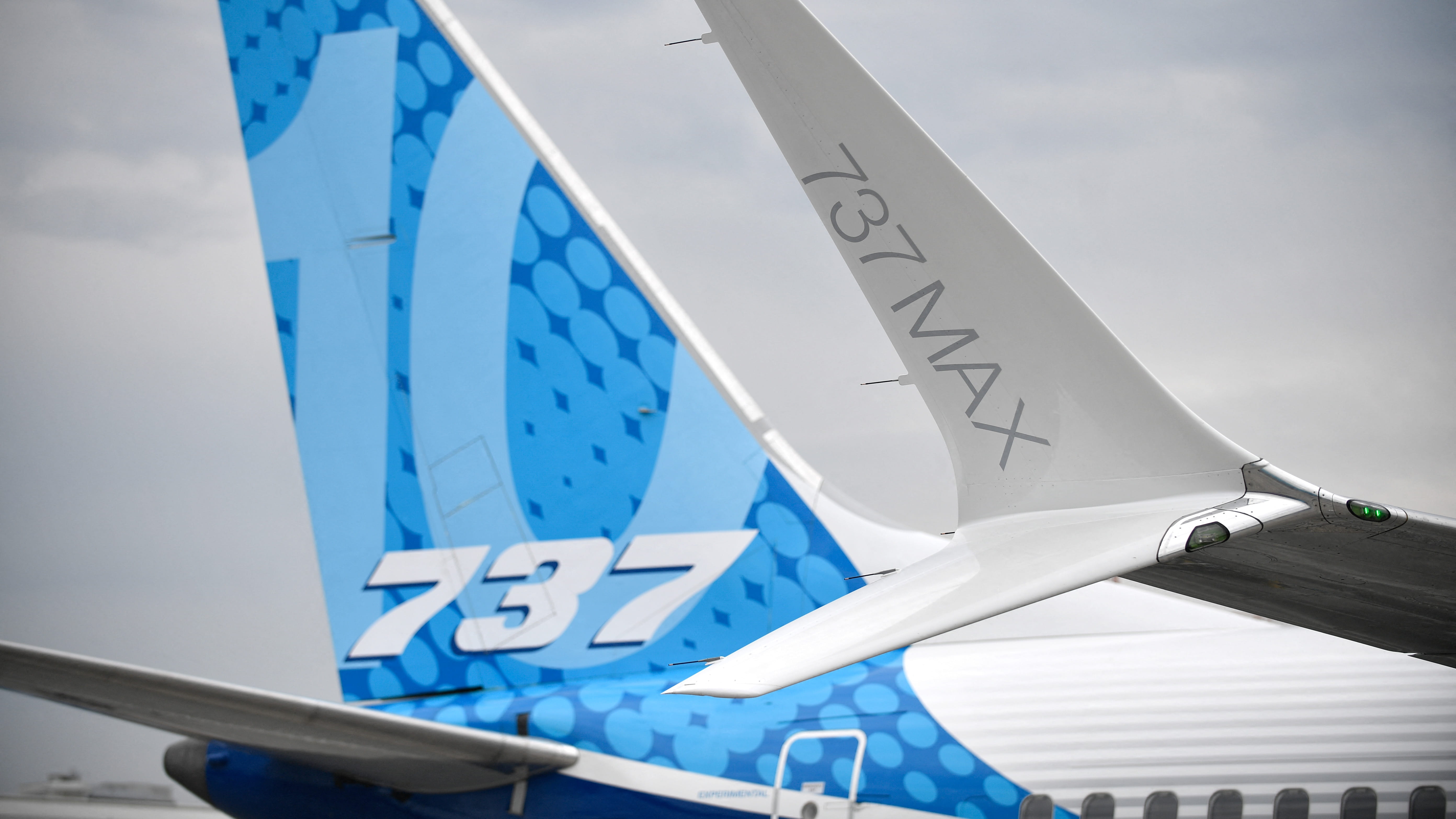 Image for the title: Boeing cuts 2023 forecast for 737 deliveries as it reports loss 