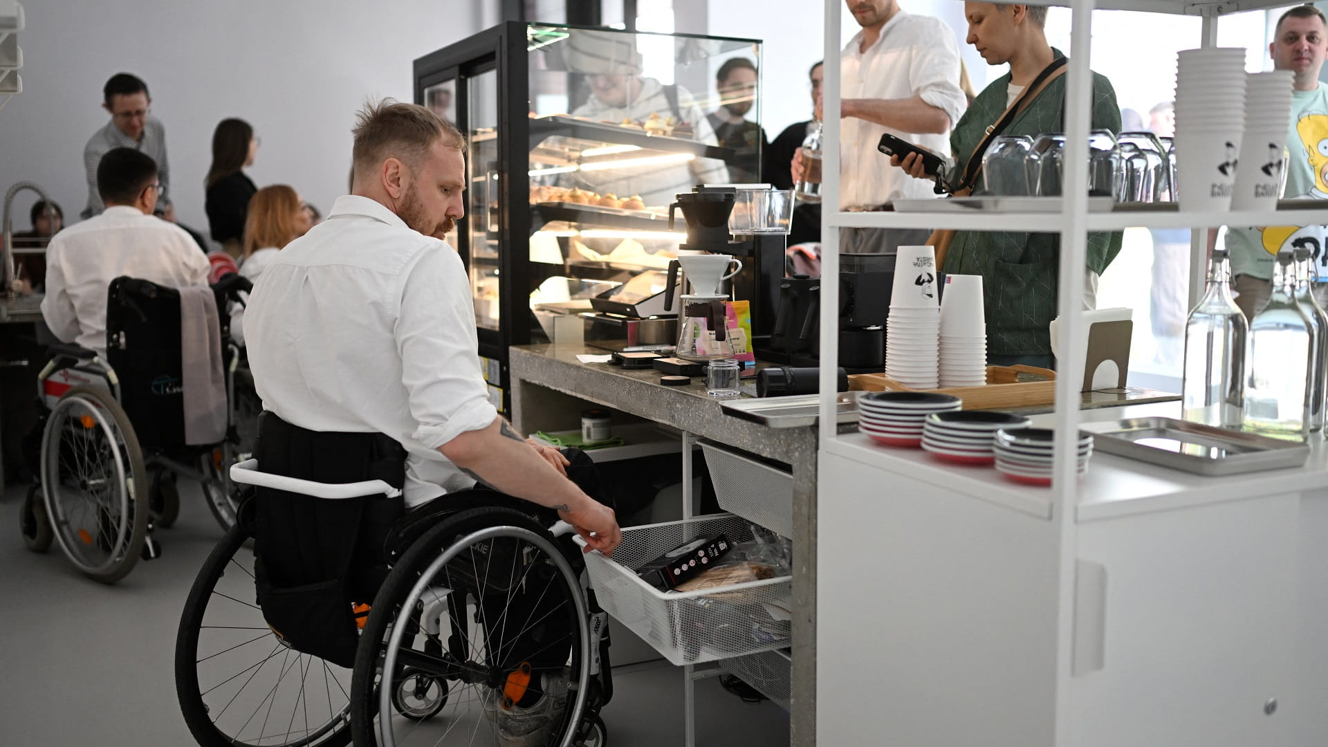 Image for the title: The Belarusian wheelchair barista 'making the world better' 