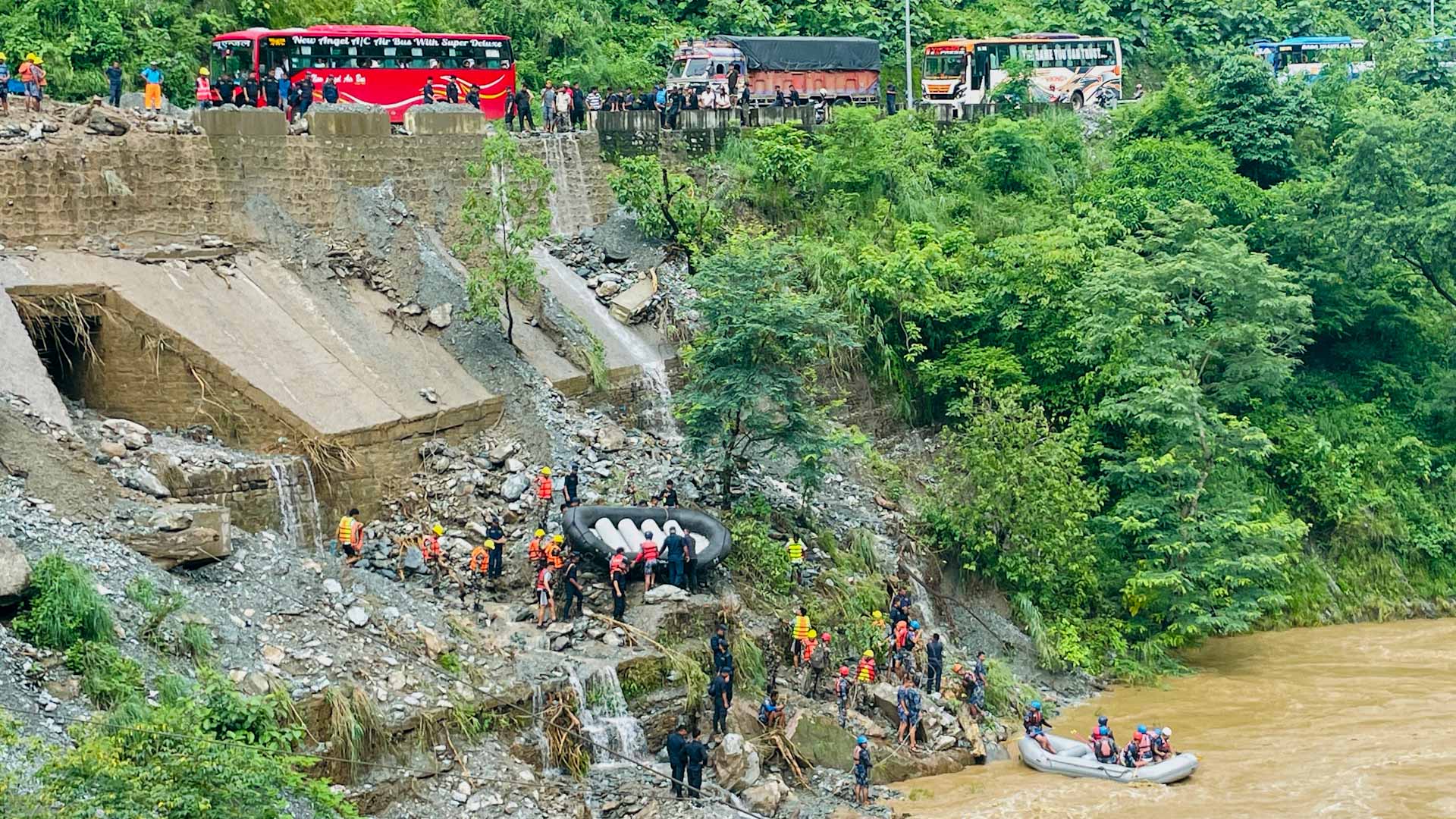 Image for the title: 63 missing after Nepal landslide sweeps two buses into river 