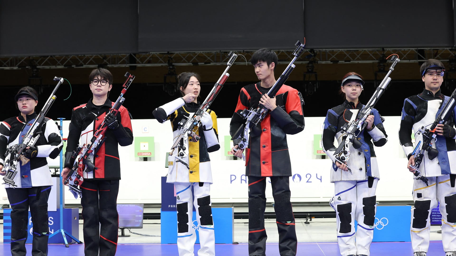 Image for the title: China takes first Olympic gold as rain disrupts Games 