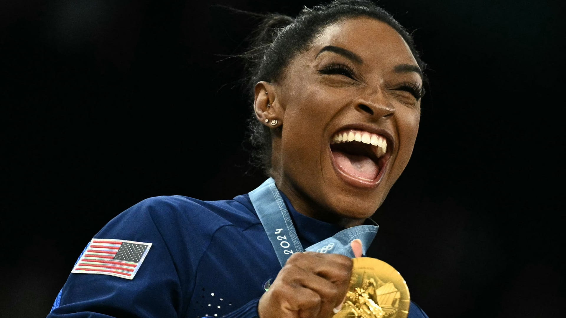 Image for the title: Biles inspires USA to Olympic gold 