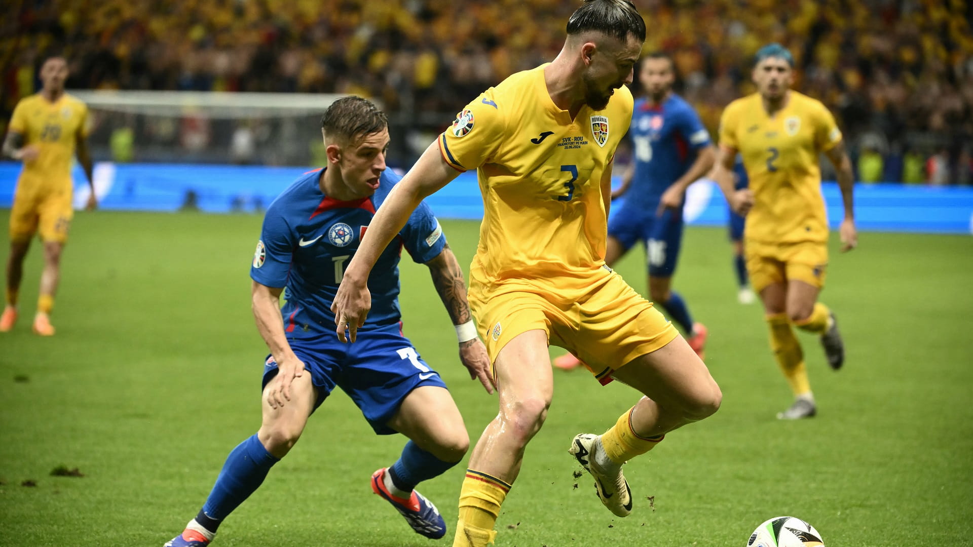 Image for the title: Romania and Slovakia reach last 16 at Euro 2024 after tense draw 