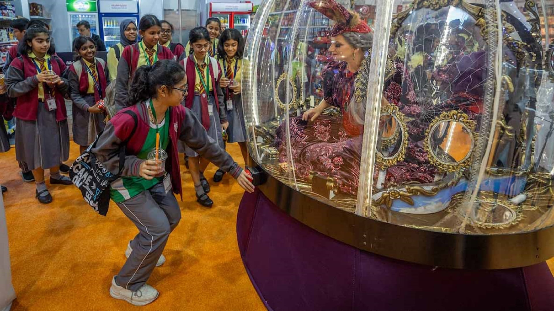 Image for the title: The lady in mystic globe enchants spectators at SIBF 