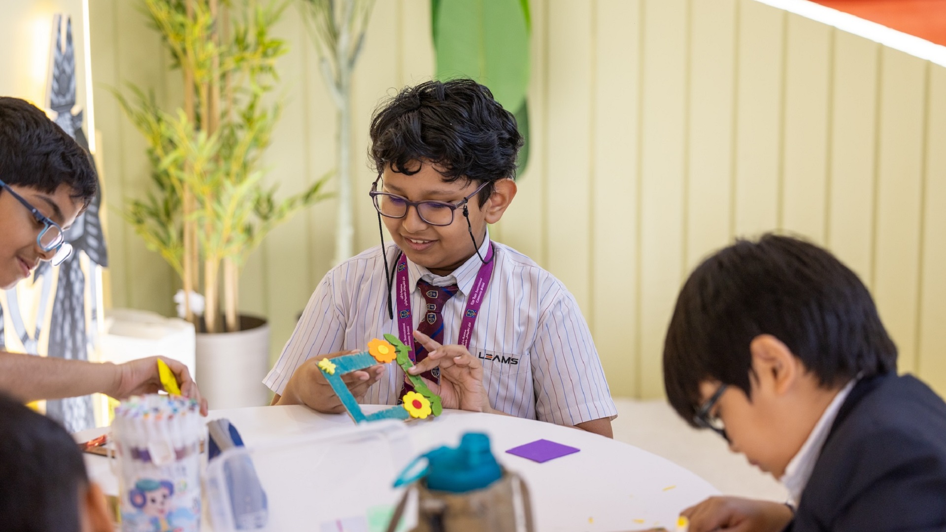 Children learn sustainability by turning waste into frame at SIBF 