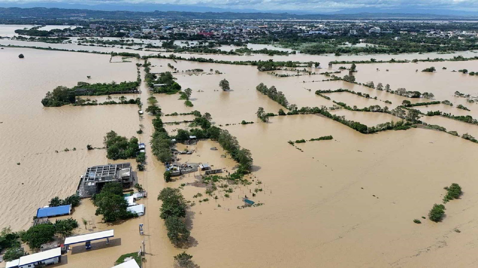 Image for the title: Tropical storm leaves towns submerged, 76 dead in Philippines 