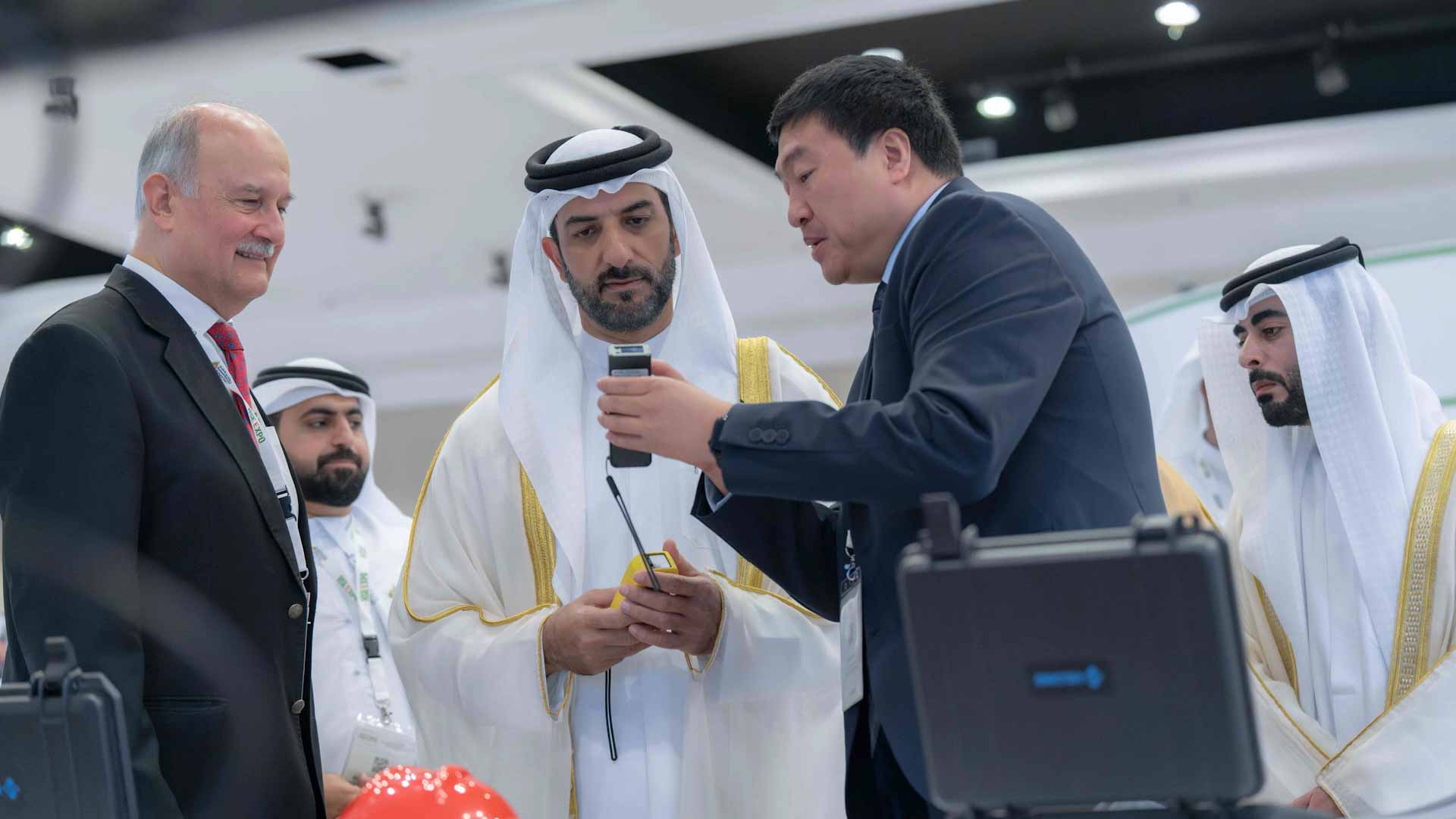 Sultan bin Ahmed listens to explanation of device at the  event