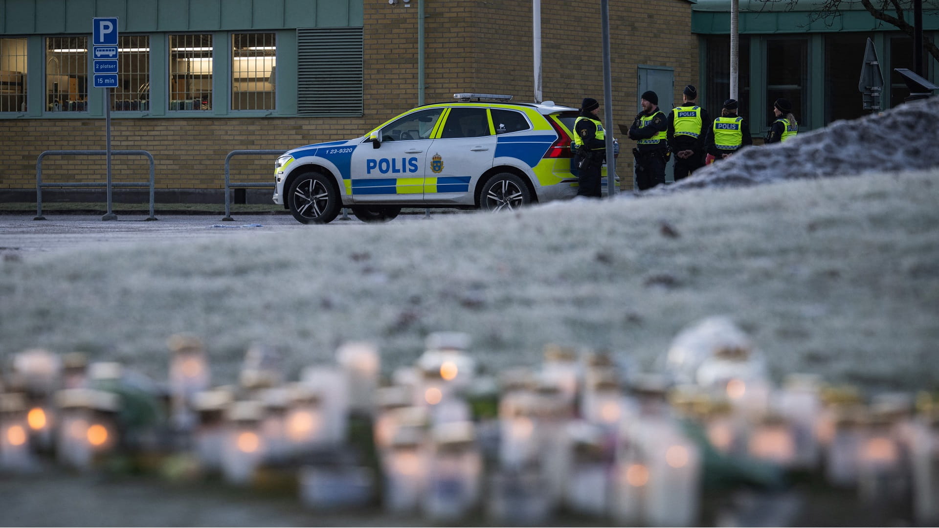 Police officers stand guard outside the adult education center Campus Risbergska school in Orebro, Sweden