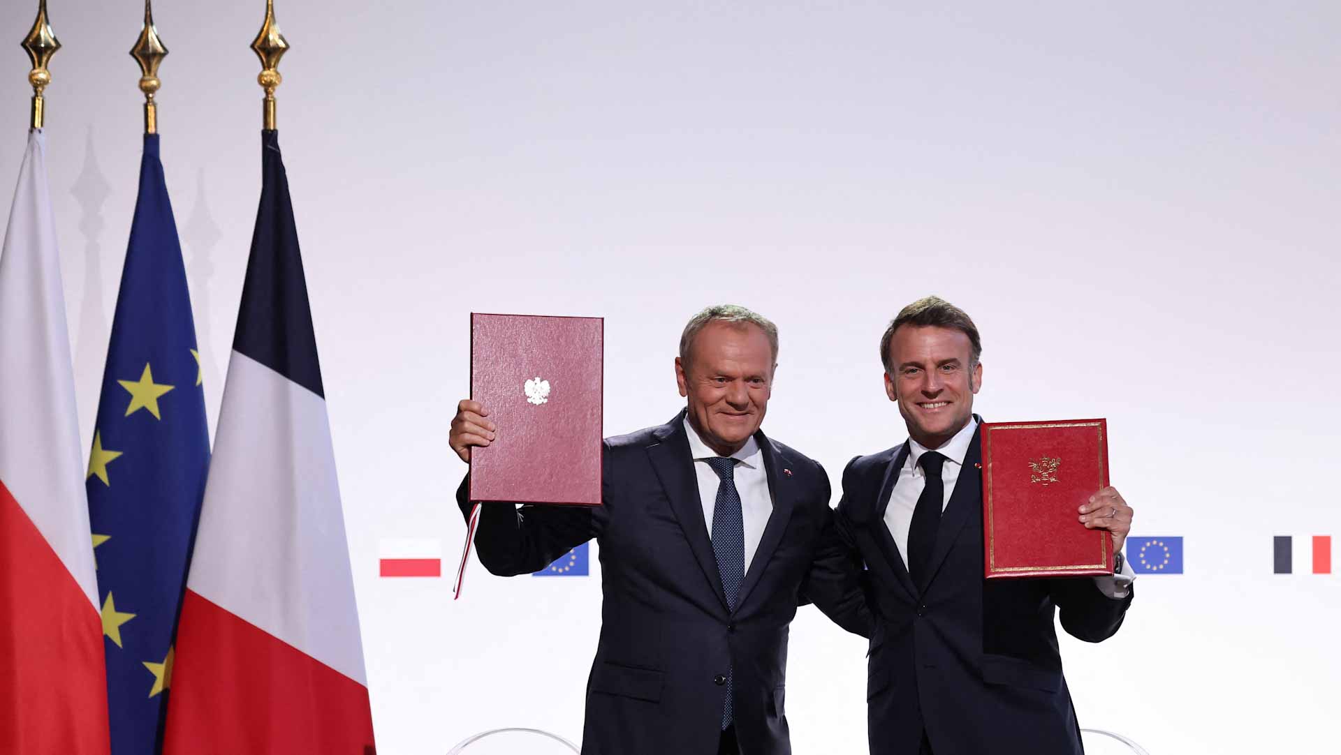 Macron, Tusk sign France-Poland treaty with mutual defence clause 