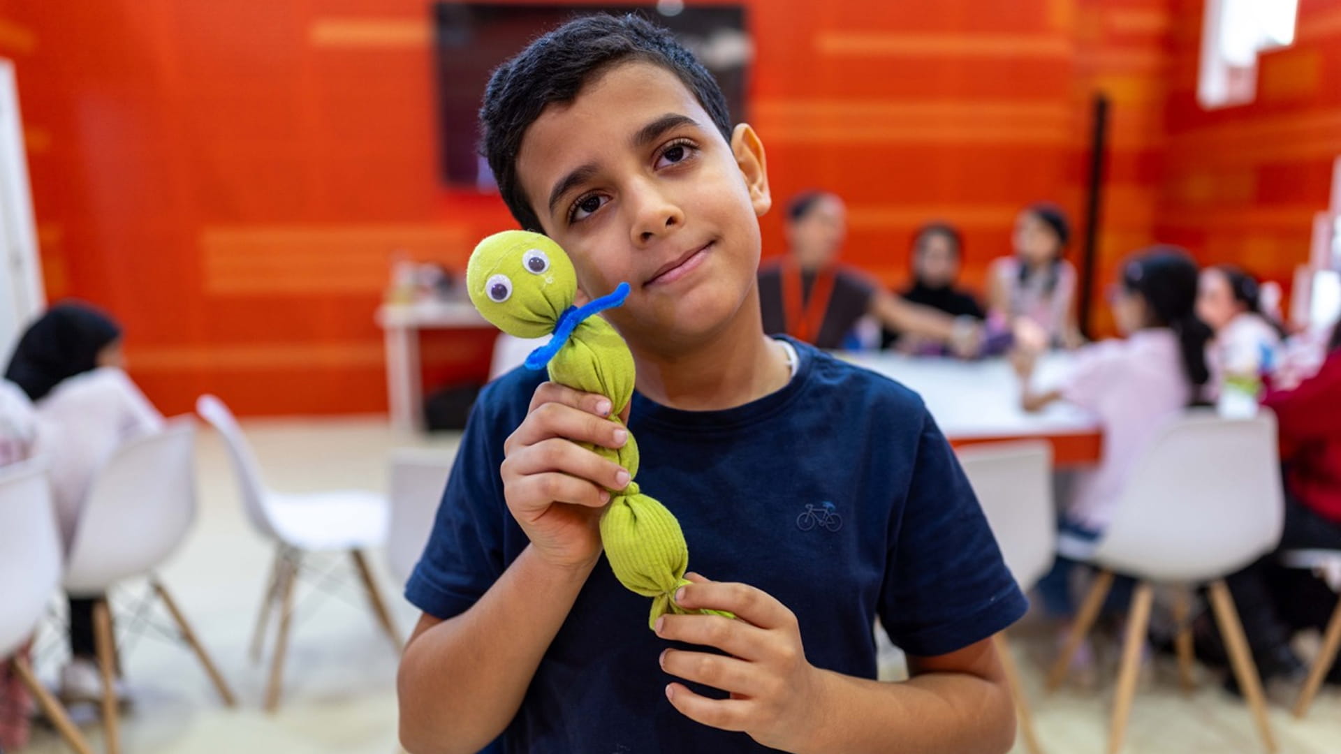 Image for the title: Children craft colourful sock dolls at SIBF 2025   