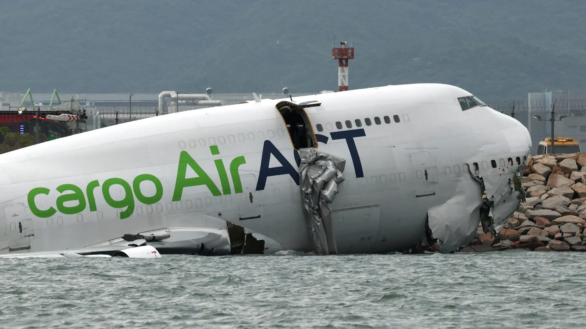 Image for the title: Two dead as cargo plane skids off runway into sea in HKSAR 