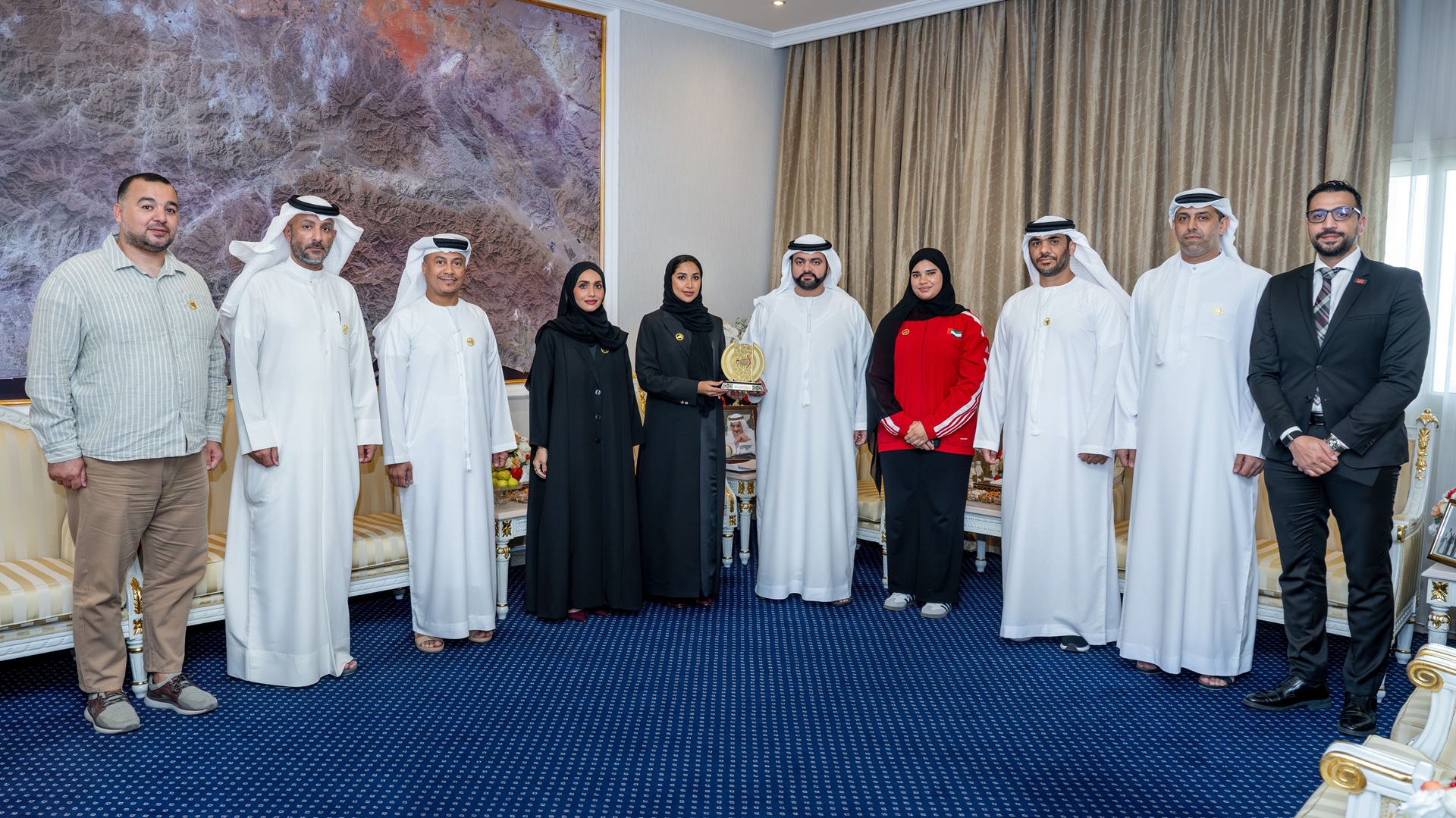 Mohammed Al Sharqi congratulates archer Huda Al Ali 